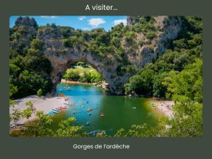 a view of a river with people swimming in it at Le Cosy Cévenol - Jardin et terrasse in Alès