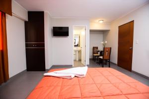 Cama ou camas em um quarto em Mariategui Hotel & Suites