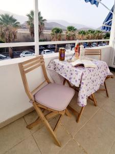 a table and chair with a book on a balcony at Sal Marina in Puertito de Güímar