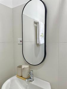 a bathroom with a mirror above a sink at Amalfi Home 2Hab AA in Montería +12 photos