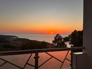 a sunset from the balcony of a house at Le Relax, Dellys 