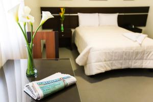 Cama ou camas em um quarto em Mariategui Hotel & Suites