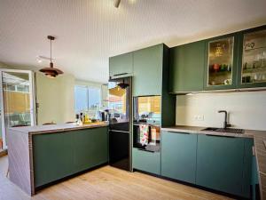 a kitchen with green cabinets and a counter top at Malaga entire rental unit in Málaga