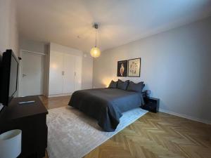 a bedroom with a bed and a television in it at City apartment with balcony in Norrköping