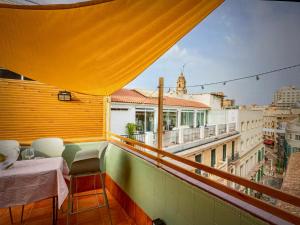 a balcony with a table and a view of a city at Malaga entire rental unit in Málaga