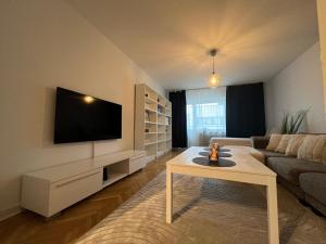 a living room with a couch and a tv at City apartment with balcony in Norrköping