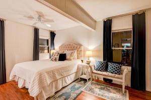 a bedroom with a white bed and a chair at Orchid Cabin in Banner Elk