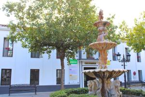 a fountain in front of a white building at Ca' Magüi in Jabugo +12 photos