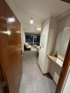 a hallway with a door leading to a living room at Frente a Playa Brava, Cerca Cavancha, WiFi in Iquique +4 photos