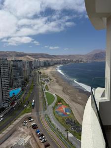 a view of the beach from the balcony of a building at Frente a Playa Brava, Cerca Cavancha, WiFi in Iquique