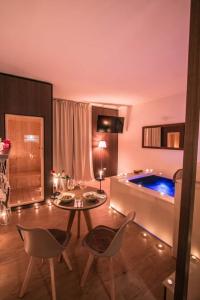 a living room with a table and a tub at Alma Suites - Il Nido d'Amore in Livorno
