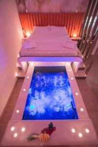 a swimming pool in a room with two beds at Alma Suites - Il Nido d'Amore in Livorno