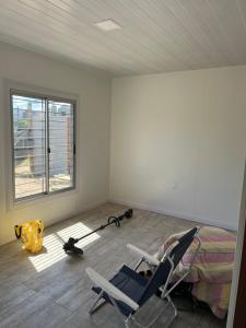 een kamer met 2 stoelen, een bed en een raam bij Porfiado in La Paloma