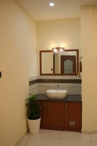 a bathroom with a sink and a mirror at Joen homes apartment in Alwaye +12 photos