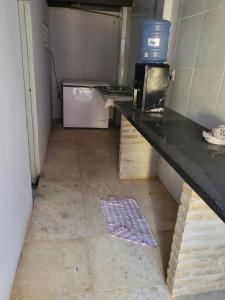 a room with a counter with a microwave on it at Casa grande Pacheco in Caucaia