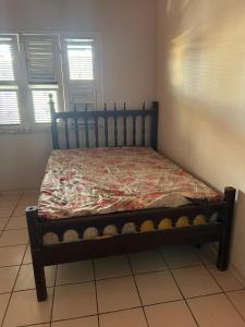 a bed in a room with a bedspread on it at Casa grande Pacheco in Caucaia