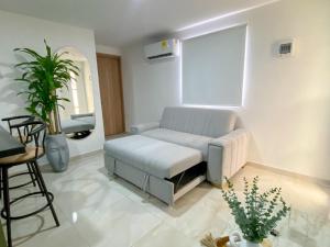 a living room with a couch and a window at Apartamento Sabaii 201 in Cartagena de Indias