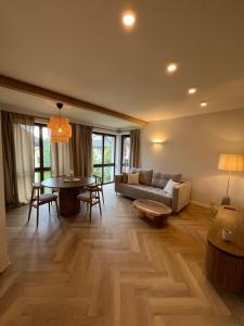 a living room with a couch and a table at Aura Medical SPA Nałęczów in Nałęczów