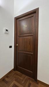 a wooden door with the number on it at Casa Baronia in Assemini +20 photos