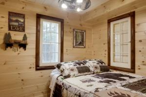 a bedroom with wooden walls and a bed in a room at Peaceful Nature Escape on Little Portage Lake! in Land O' Lakes