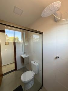 ein Badezimmer mit Toilette und Dusche in der Unterkunft Casa com ar condicionado, churrasqueira e rooftop in Alto Paraíso de Goiás