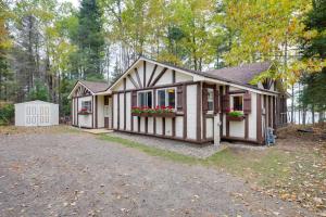 a small house with flowers in the front yard at Peaceful Nature Escape on Little Portage Lake! in Land O' Lakes