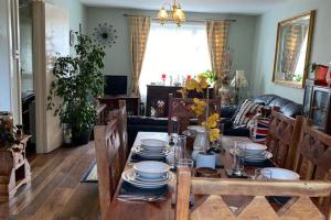 a living room with a table with plates on it at 2-Bed House Sleeps 4 - Enclosed Garden - Tv & WiFi in Amesbury