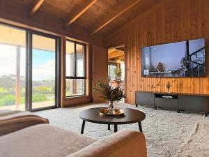 a living room with a large flat screen tv at Delamere Farm Stay in Delamere