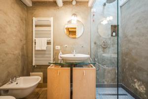 a bathroom with a sink and a shower at Romeos Cottage Public free parking bike rental in Verona +22 photos