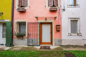 a pink building with a door and windows at Romeos Cottage Public free parking bike rental in Verona