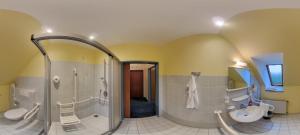 a large bathroom with a shower and a sink at Hotel Restaurant Zum Jägerheim in Braunschweig