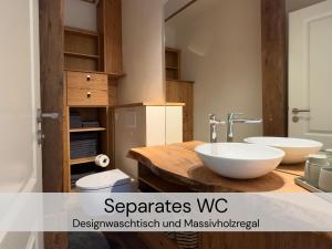 a bathroom with two sinks on a wooden counter at HexenburgbeiDresden 3 Zimmer Architektengaleriewohnung mit eigener Sauna, 2 Kaminen - Nähe Sächsische Schweiz Dresden in Großharthau +48 photos