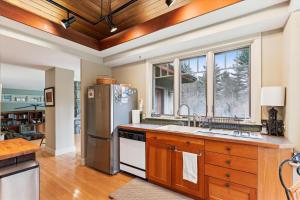 a kitchen with a stainless steel refrigerator and a window at Raven's Nest in Stowe