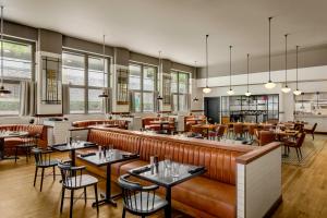 a restaurant with tables and chairs and a bar at Renaissance Atlanta Midtown Hotel in Atlanta