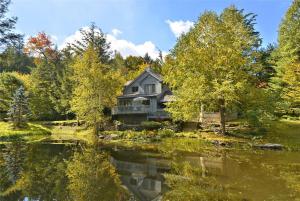 a house in the middle of a lake at Spruce Pond Haven in Stowe