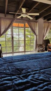 a large bed in a room with a large window at MountainzenEscape in Los Altos de Cerro Azul