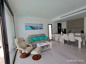 a living room with a couch and chairs and a table at Casa Kempie in San Javier