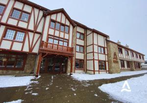 een groot gebouw met een balkon in de sneeuw bij Almasur Punta Arenas in Punta Arenas
