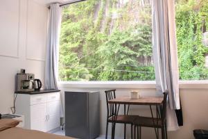 a kitchen with a table and a large window at Mayad Boutique Hotel El Nido - Newly Renovated in El Nido
