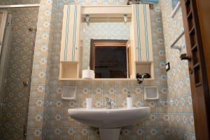 a bathroom with a sink and a mirror at Aurooms in Cinisi