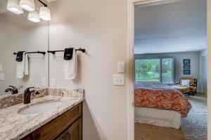 a bathroom with a sink and a bed in a room at Lakes View at Hound Ears in Valle Crucis +38 photos