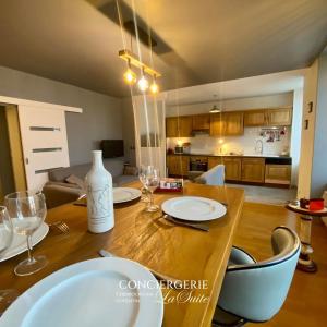 a dining room table with plates and wine glasses at La Passerelle in Cherbourg en Cotentin +6 photos