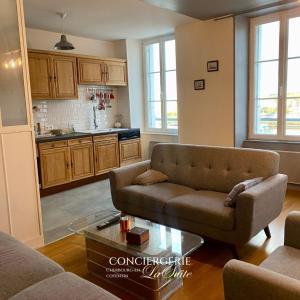 a living room with a couch and a table at La Passerelle in Cherbourg en Cotentin