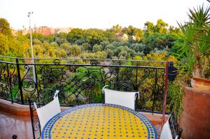 a balcony with a table and a view of a garden at appartement el harti in Oulad Akkou