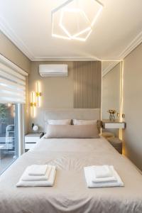 a bedroom with a bed with two towels on it at Kaltak Luxury Stay in Bar