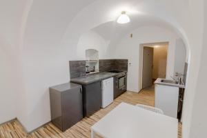 a kitchen with a sink and a counter top at Útulný apartmán v srdci Jihlavy in Jihlava
