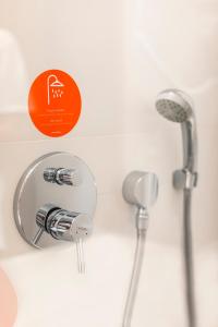 a shower with a shower head on a wall at Hotel Moov Curitiba in Curitiba
