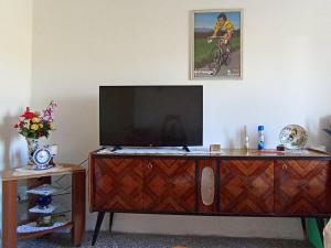 a television on top of a wooden entertainment center at OldHouse in Albergo