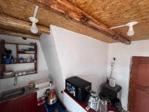 a kitchen with a counter with a microwave and a ceiling at Sky Garden in Cusco +17 photos