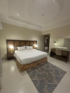 Habitación grande con cama grande y escritorio. en مذهله للوحدات السكنيه, en Muhayil